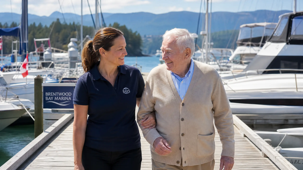 Senior receiving professional in-home care support at Brentwood Bay marina with sailboats and mountain views